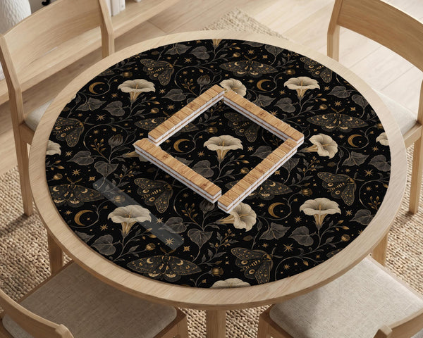 Black square mahjong mat with moths, moonflowers, crescent moons, and scattered stars in a celestial floral pattern.