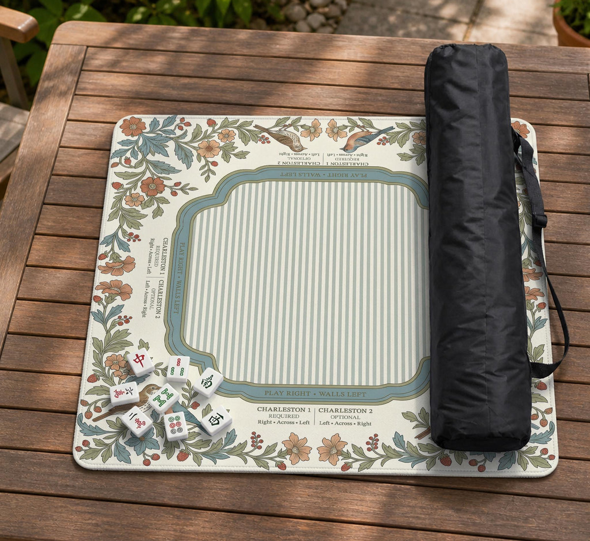 Square mahjong mat with a cream background, blue birds, sage leaves, terracotta flowers, and a decorative botanical border with printed rules text.