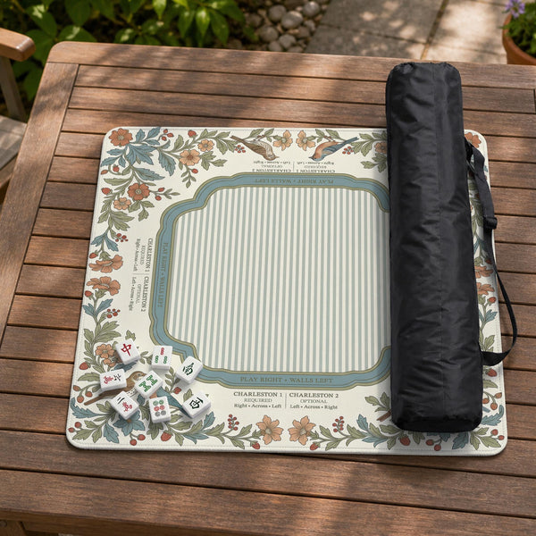 Square mahjong mat with a cream background, blue birds, sage leaves, terracotta flowers, and a decorative botanical border with printed rules text.