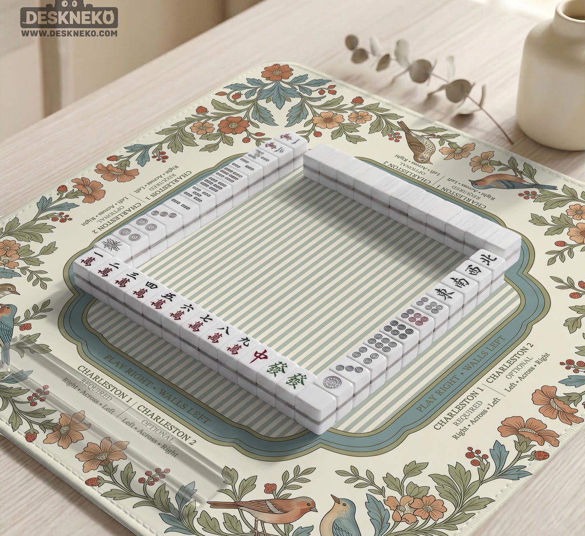 Square mahjong mat with a cream background, blue birds, sage leaves, terracotta flowers, and a decorative botanical border with printed rules text.
