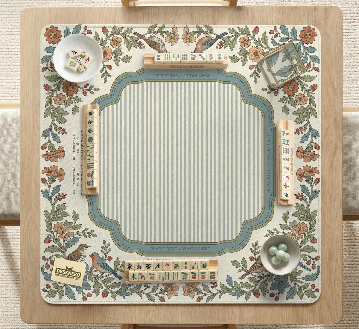 Square mahjong mat with a cream background, blue birds, sage leaves, terracotta flowers, and a decorative botanical border with printed rules text.