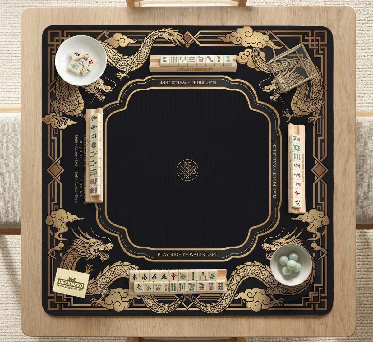 Black mahjong mat with gold dragon artwork, a scalloped edge, and printed Mahjong rules on the surface.
