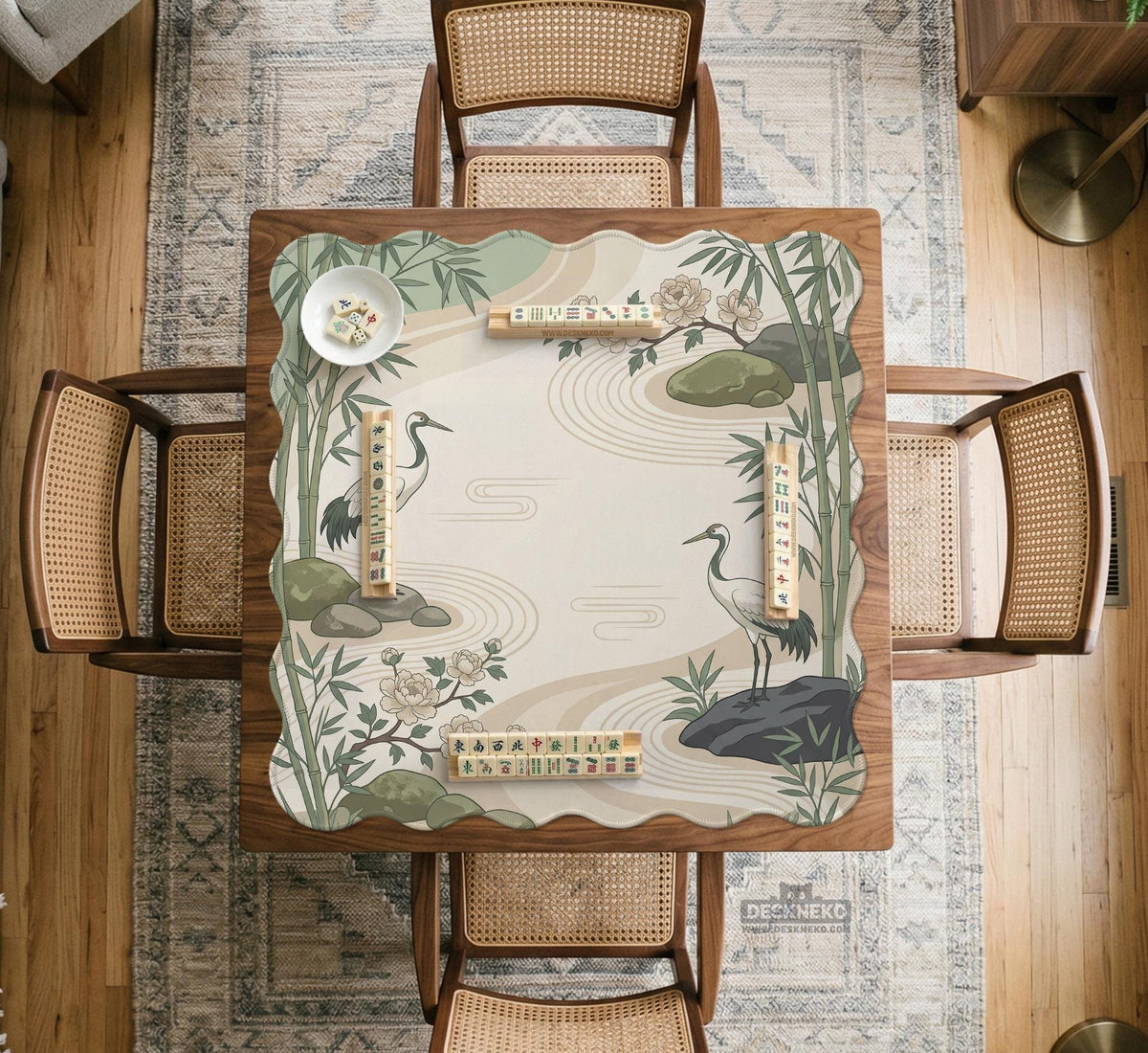 Square mahjong mat with a cream background, sage green cranes, bamboo leaves, peony branches, stones, and thin linework.
