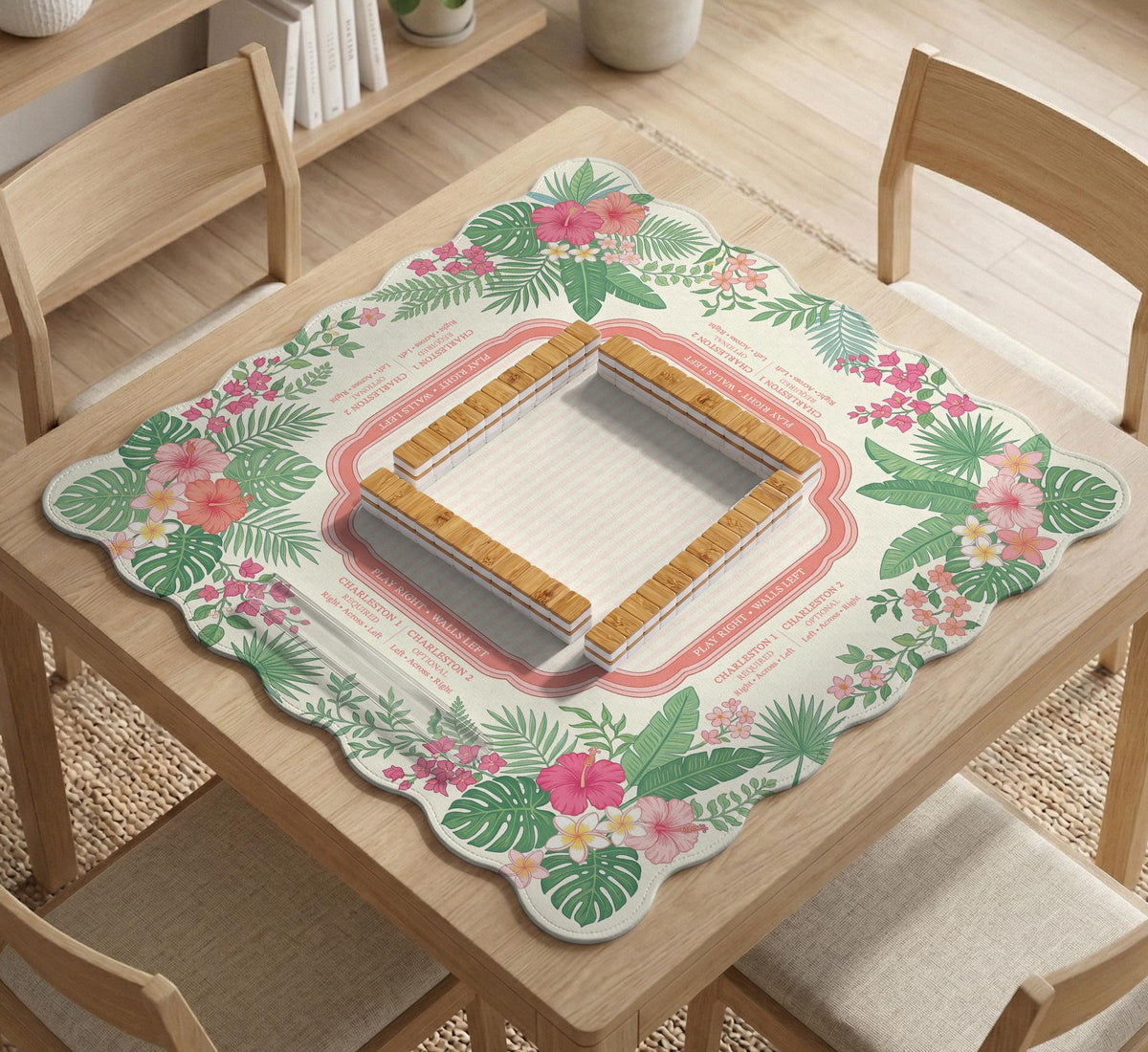 Coral tropical floral mahjong mat with hibiscus flowers, palm leaves, cream sections, and a scalloped edge.
