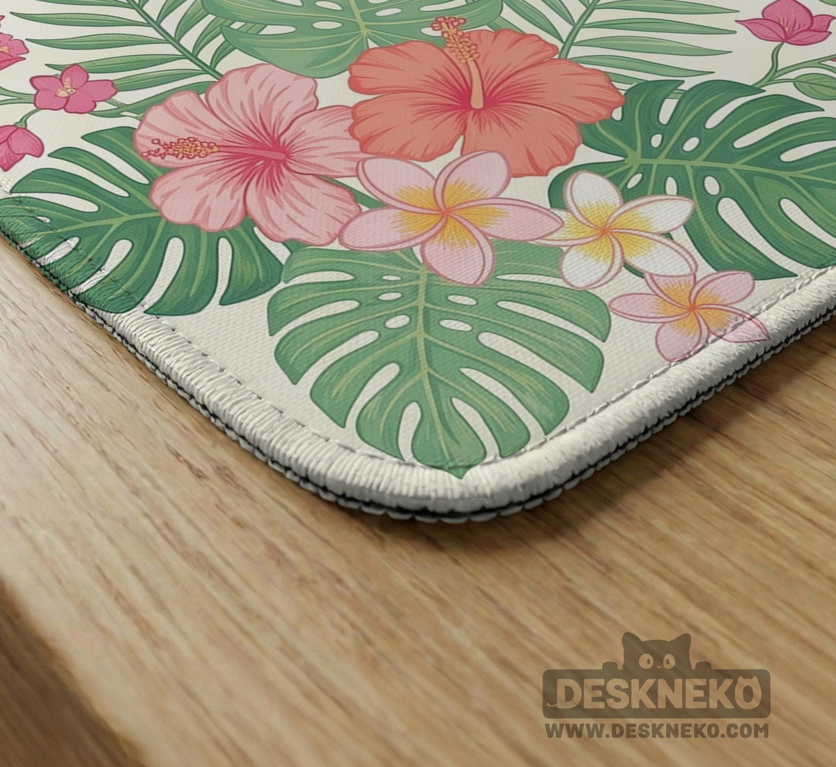 Coral tropical floral mahjong mat with hibiscus flowers, palm leaves, cream sections, and a scalloped edge.