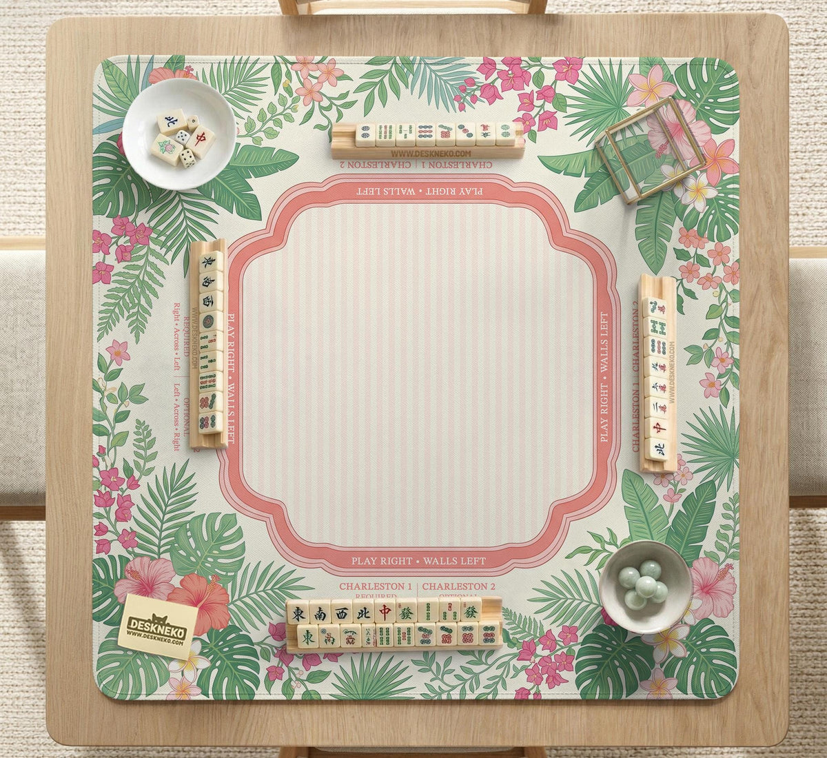 Coral tropical floral mahjong mat with hibiscus flowers, palm leaves, cream sections, and a scalloped edge.