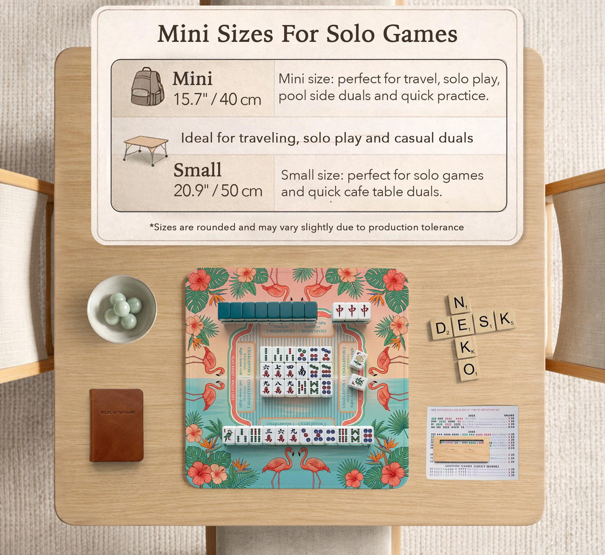 A square mahjong mat with flamingos, hibiscus flowers, palm leaves, and aqua water accents on a coral background with a scalloped edge.