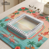 A square mahjong mat with flamingos, hibiscus flowers, palm leaves, and aqua water accents on a coral background with a scalloped edge.