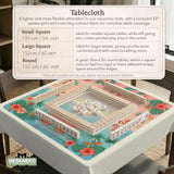 A square mahjong mat with flamingos, hibiscus flowers, palm leaves, and aqua water accents on a coral background with a scalloped edge.