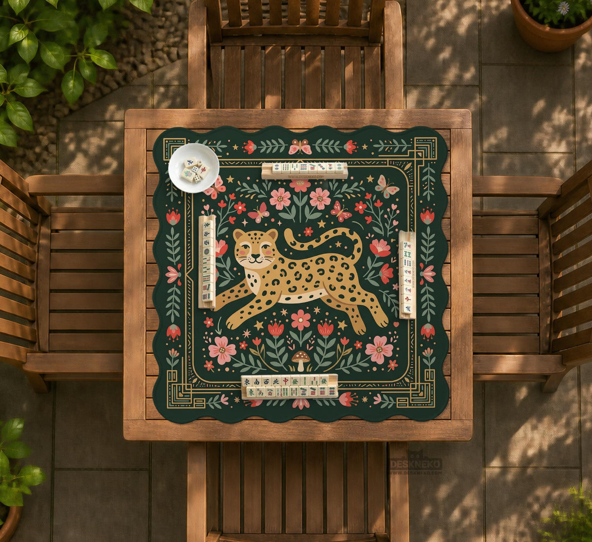 Dark green square mahjong mat with a golden spotted leopard in the center, surrounded by flowers, leafy stems, butterflies, and small star accents.