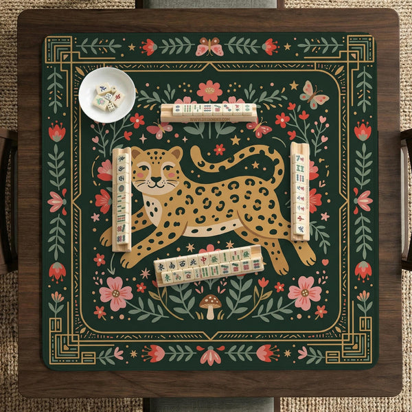 Dark green square mahjong mat with a golden spotted leopard in the center, surrounded by flowers, leafy stems, butterflies, and small star accents.