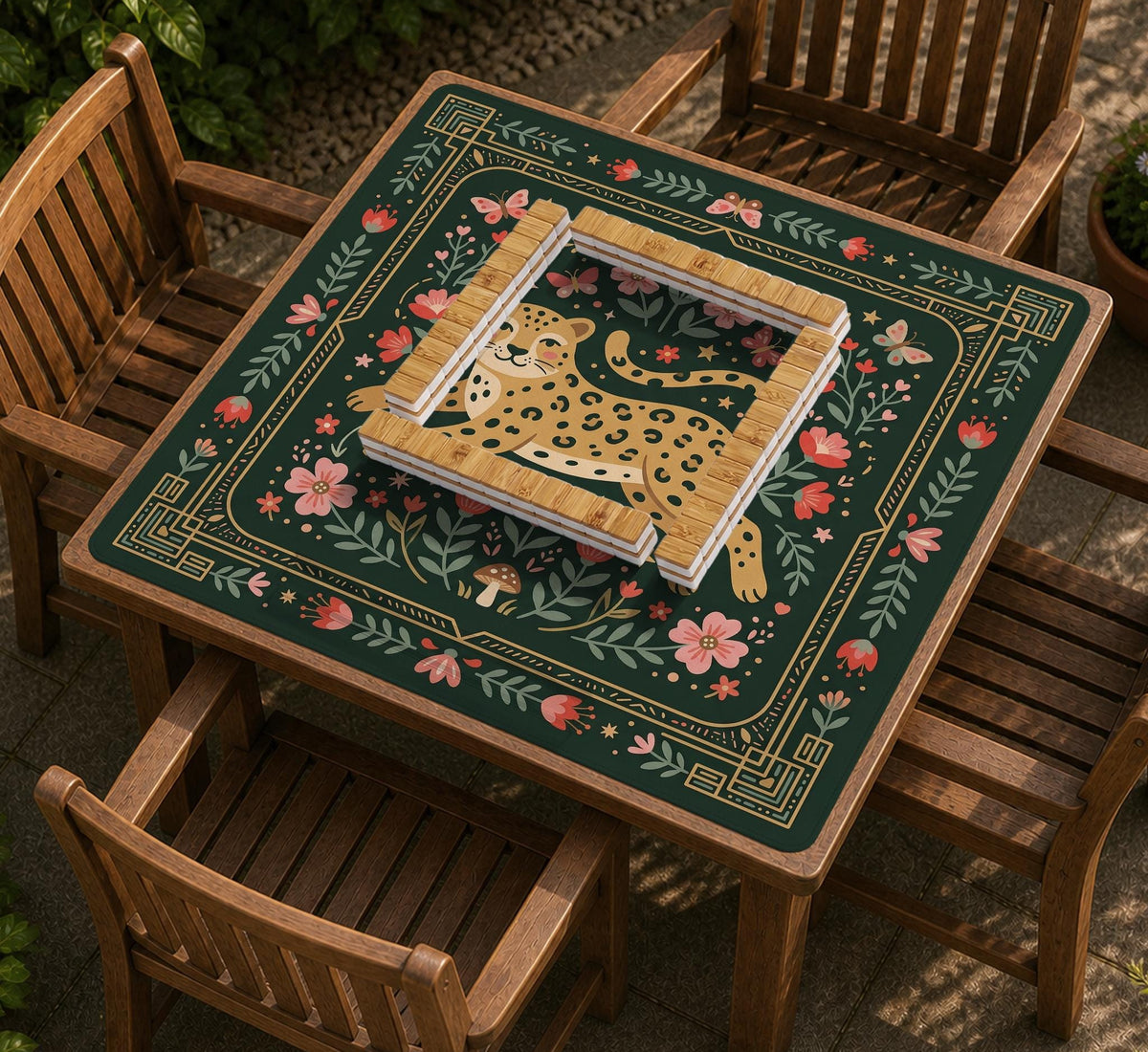 Dark green square mahjong mat with a golden spotted leopard in the center, surrounded by flowers, leafy stems, butterflies, and small star accents.