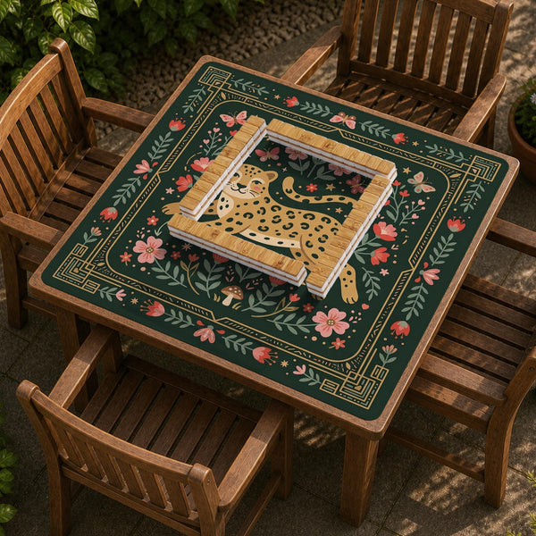 Dark green square mahjong mat with a golden spotted leopard in the center, surrounded by flowers, leafy stems, butterflies, and small star accents.