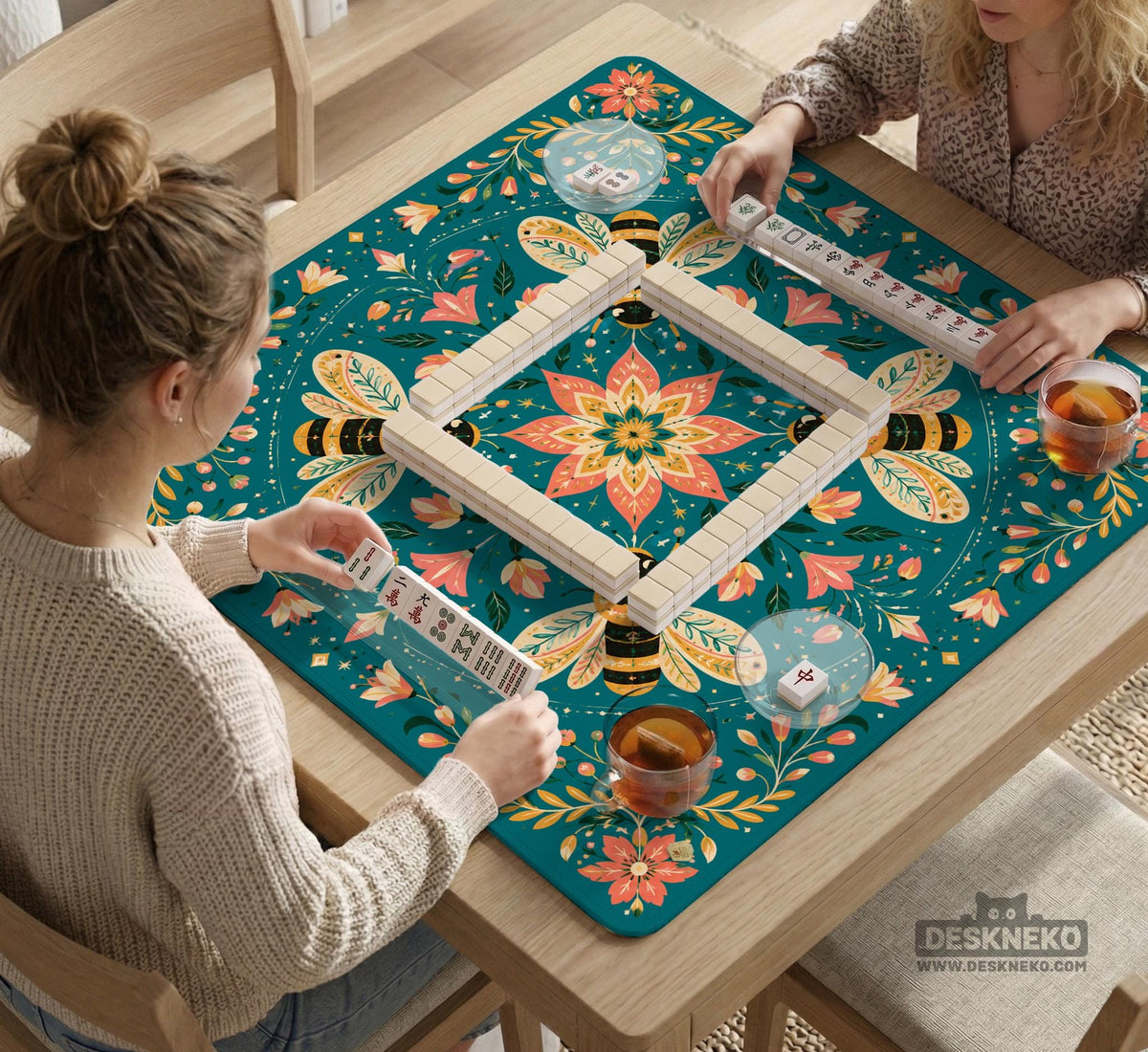 Green mahjong mat with a botanical bee and floral mandala design in teal, coral, cream, and gold.