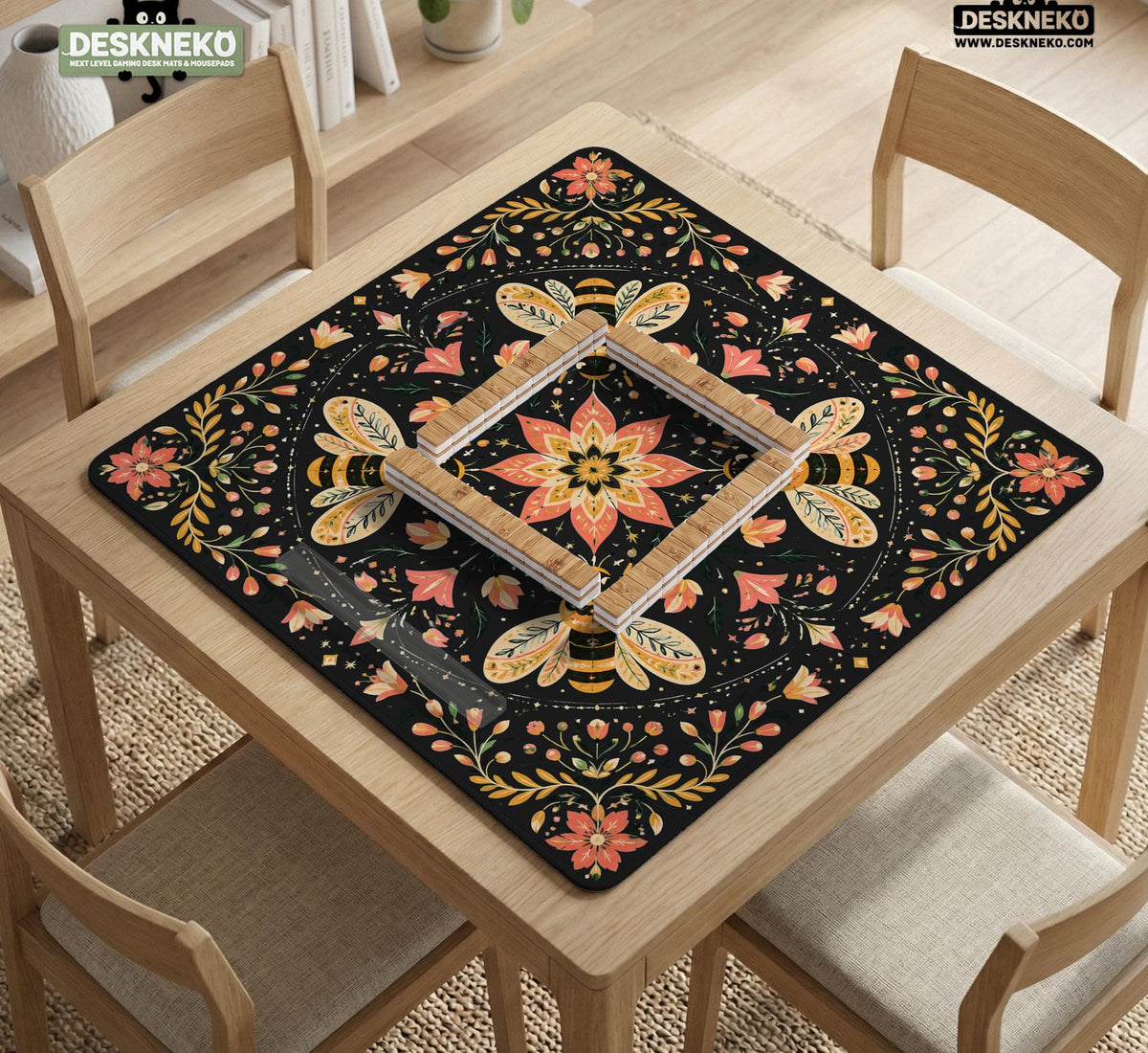 Black mahjong mat with a symmetrical botanical design, coral flowers, golden leaves, and small bees.