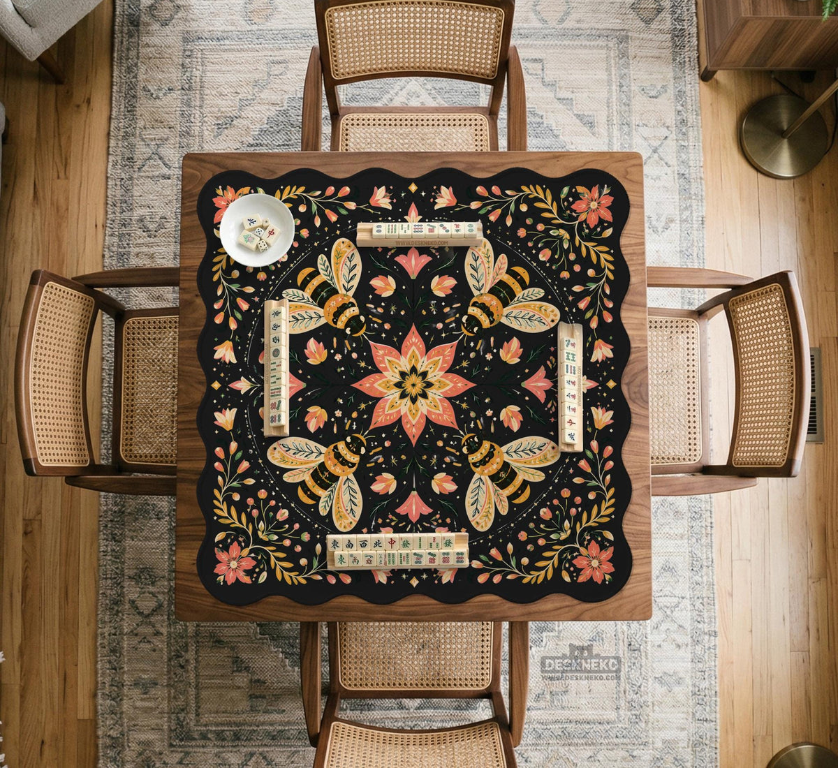 Black mahjong mat with a symmetrical botanical design, coral flowers, golden leaves, and small bees.