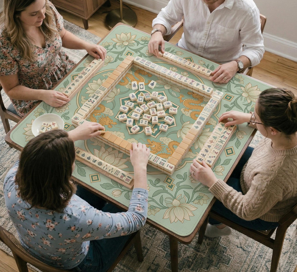 Sage green square mahjong mat with lotus flowers, golden dragons, and an ornamental center design.