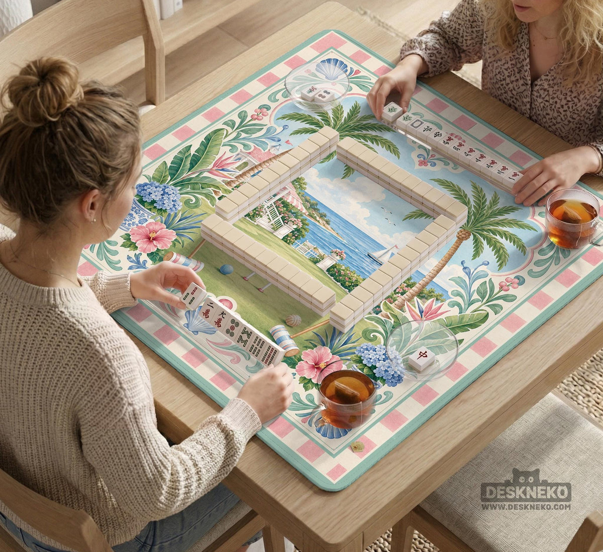 Pastel mahjong mat with a pink gingham border, seashells, hydrangea pots, palm trees, croquet details, and a coastal garden scene.