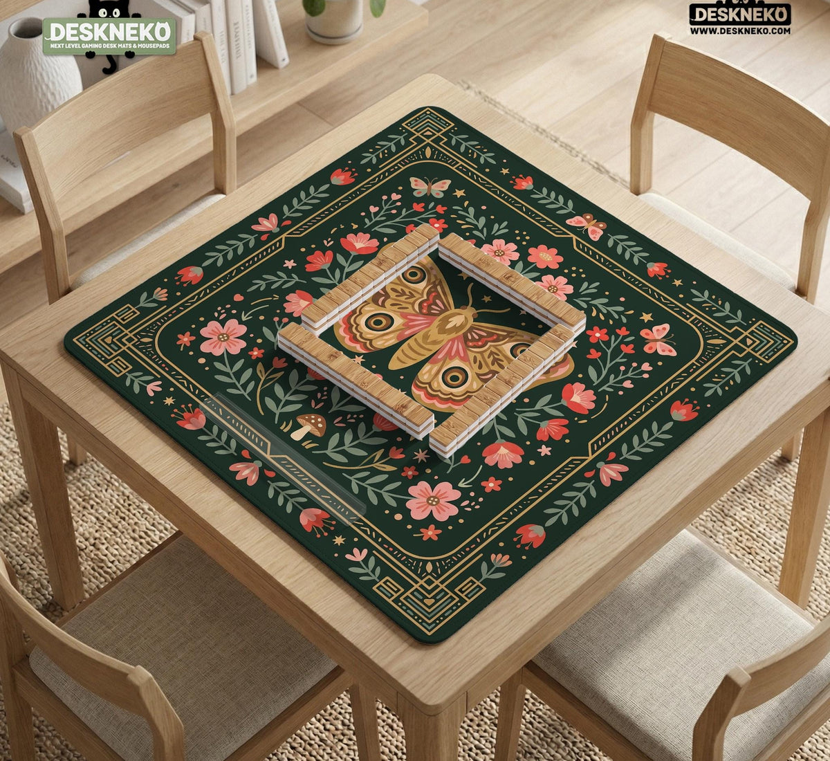 Dark green square mahjong mat with floral branches, small red blossoms, gold line details, and a large moth in the center.