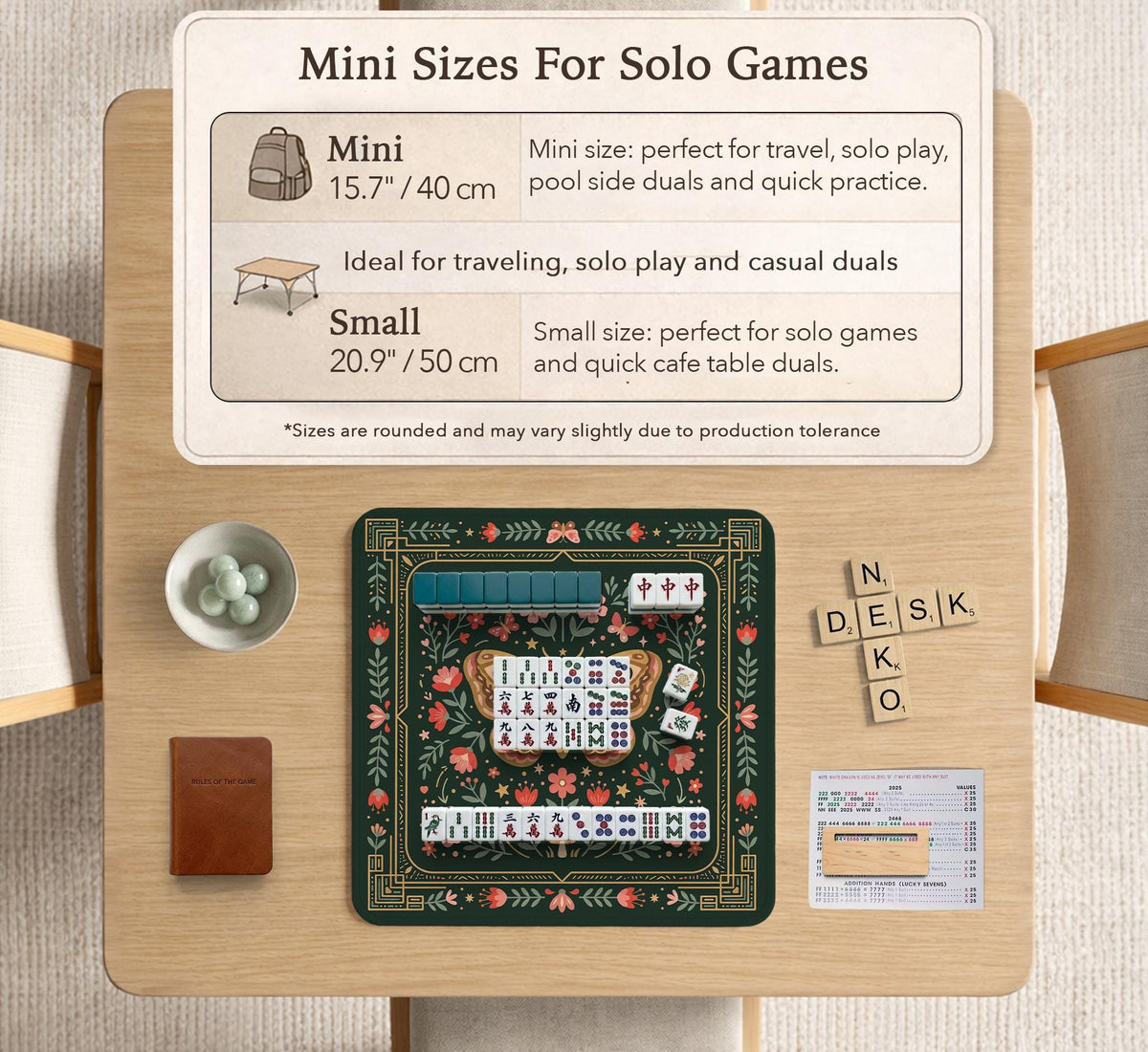 Dark green square mahjong mat with floral branches, small red blossoms, gold line details, and a large moth in the center.