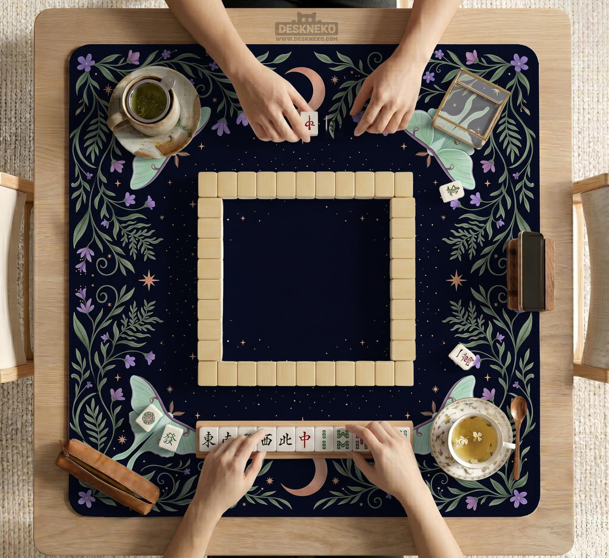Navy square mahjong mat with a floral border, copper moons, scattered stars, pale moths, and leafy botanical details.