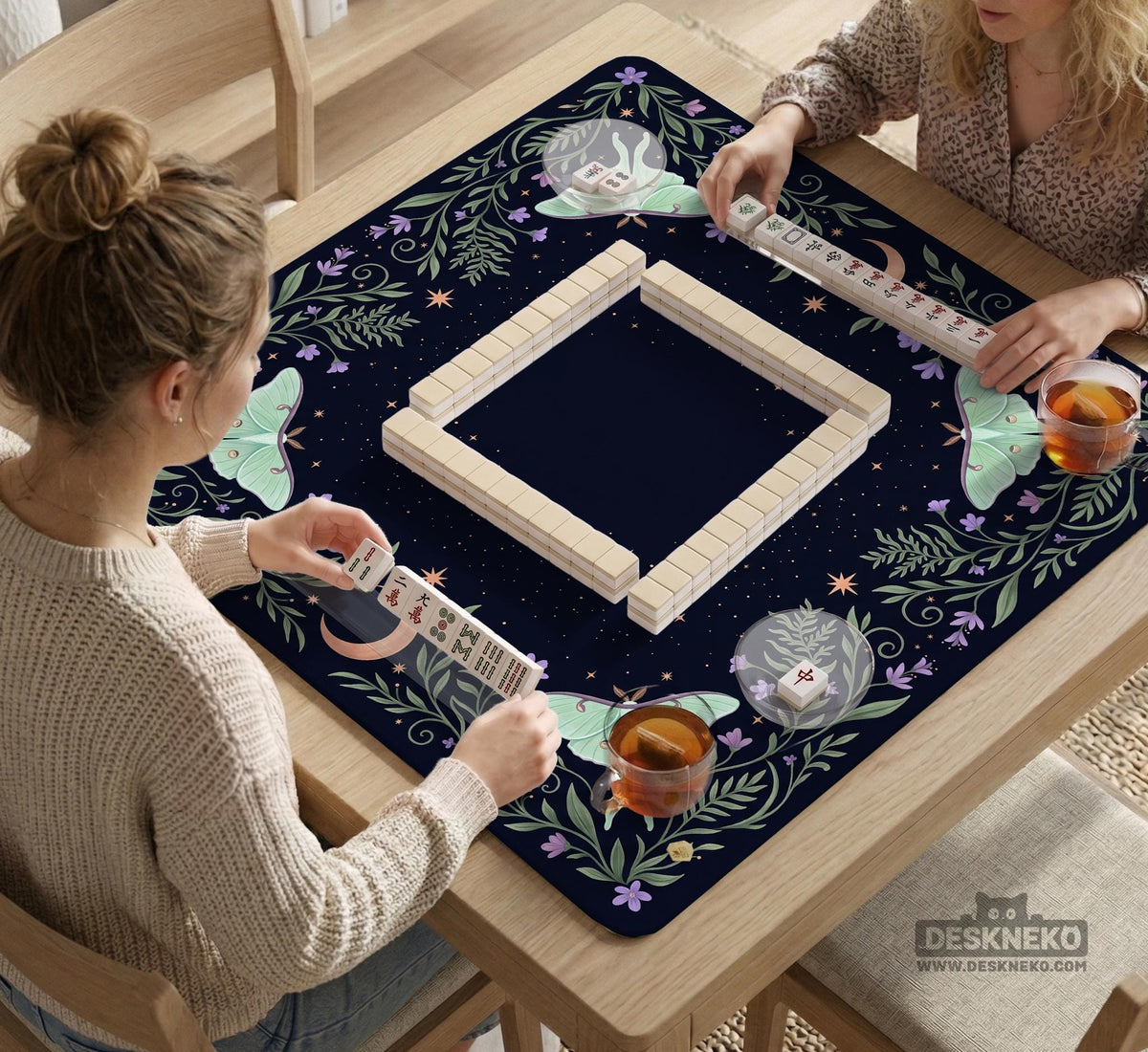 Navy square mahjong mat with a floral border, copper moons, scattered stars, pale moths, and leafy botanical details.