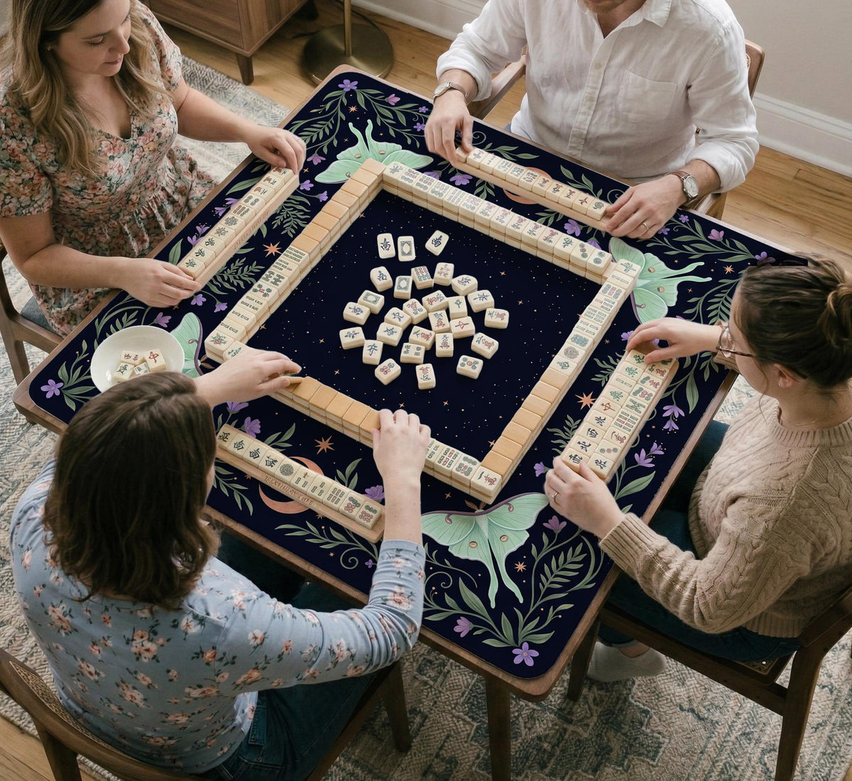 Navy square mahjong mat with a floral border, copper moons, scattered stars, pale moths, and leafy botanical details.