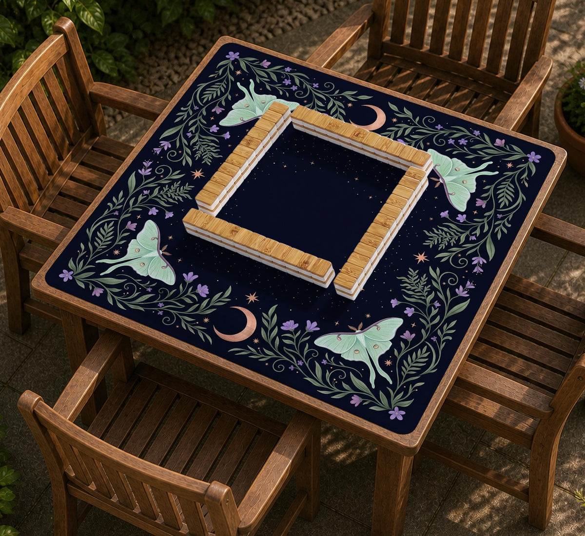 Navy square mahjong mat with a floral border, copper moons, scattered stars, pale moths, and leafy botanical details.