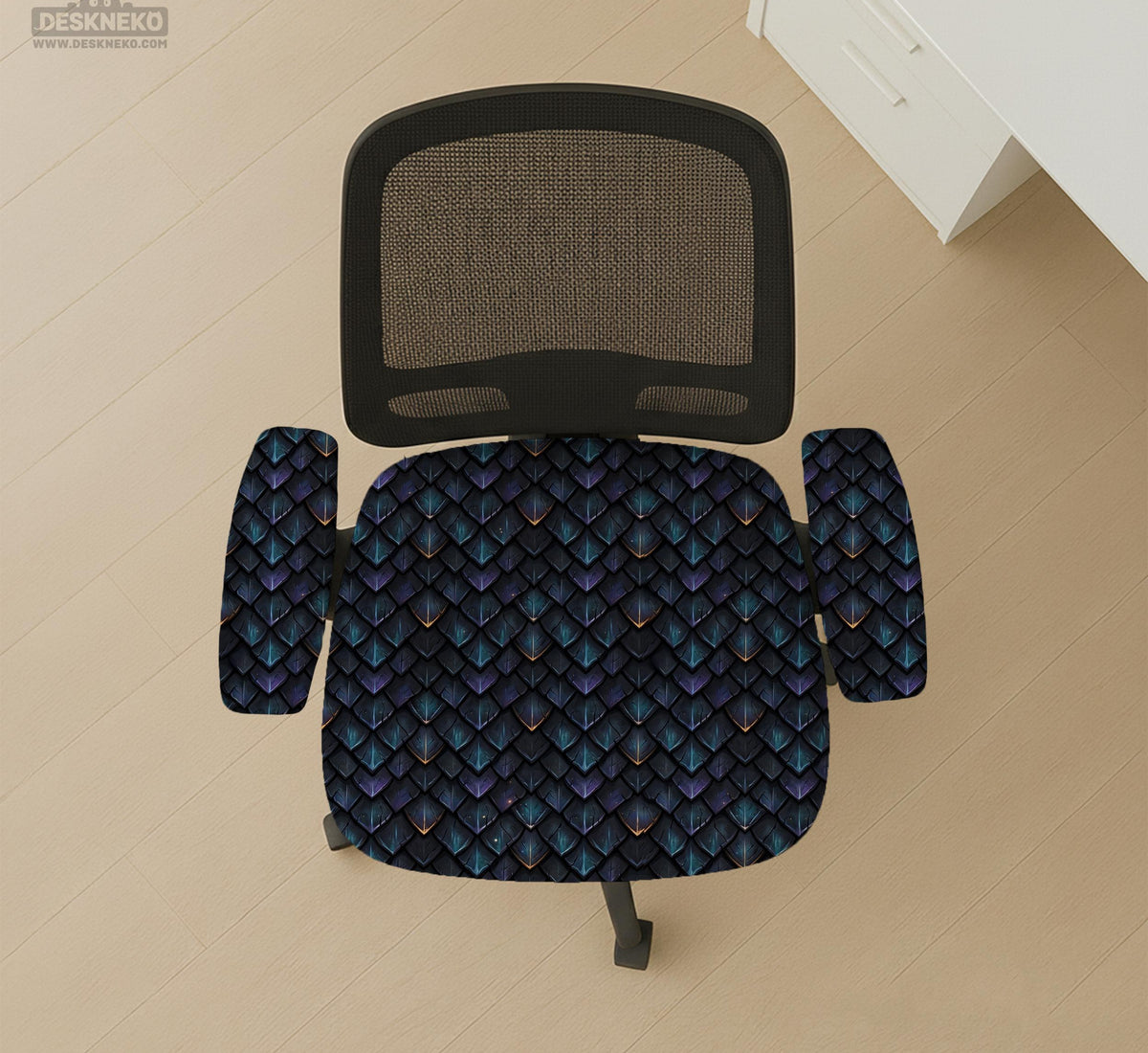 An indigo desk chair cover with a dragon scale pattern in blue, navy, purple, and copper tones, shown as a stretch slipcover with coverage options.