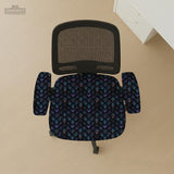 An indigo desk chair cover with a dragon scale pattern in blue, navy, purple, and copper tones, shown as a stretch slipcover with coverage options.