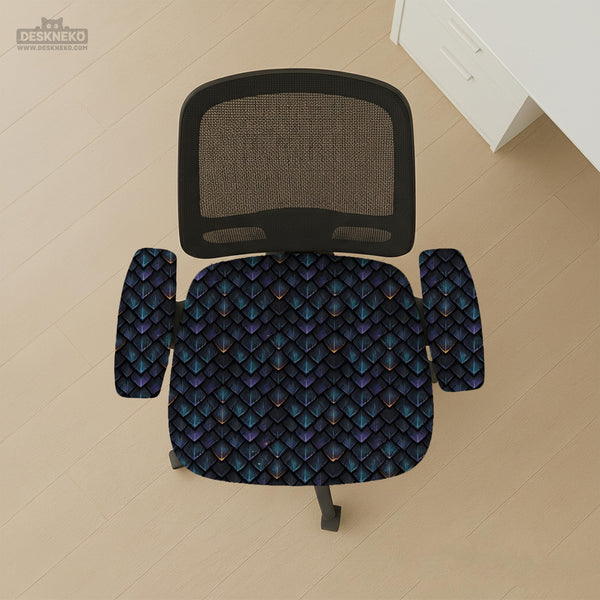 An indigo desk chair cover with a dragon scale pattern in blue, navy, purple, and copper tones, shown as a stretch slipcover with coverage options.