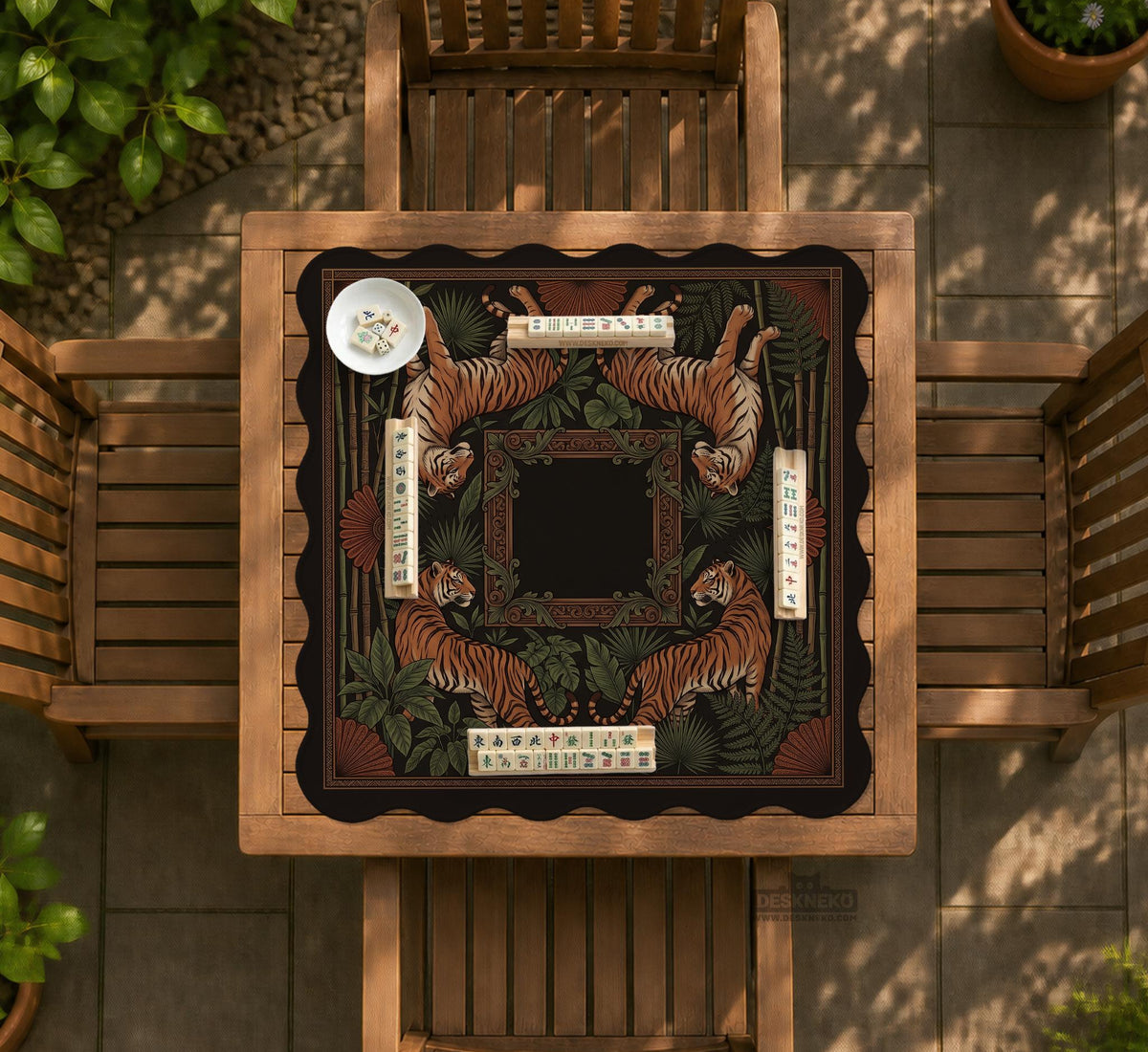Black square mahjong mat with mirrored tiger faces, bamboo, dark tropical leaves, ornate border details, and orange accents.