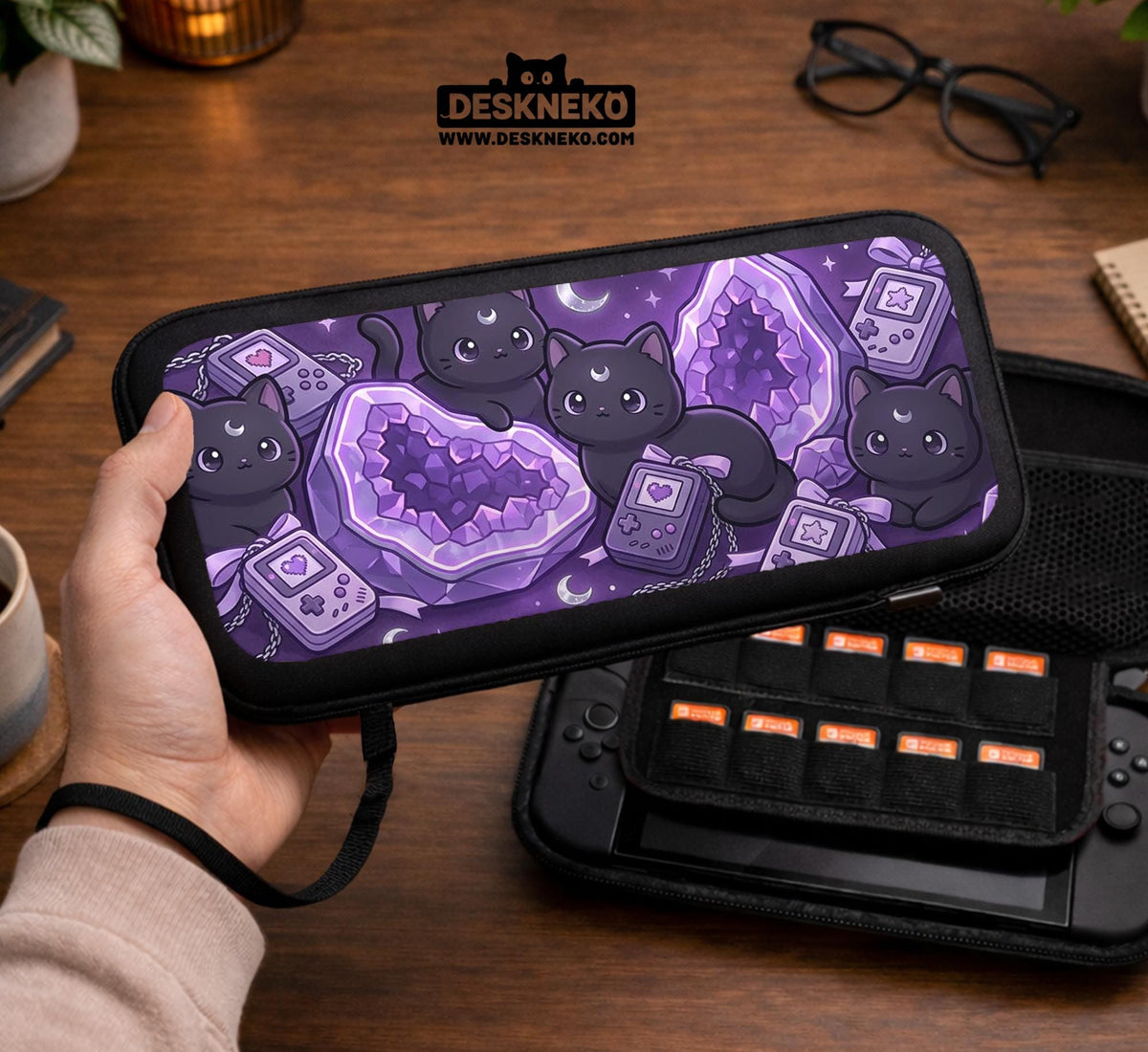 Purple carrying case with black cat faces, moon shapes, stars, and crystal geode style artwork for Nintendo Switch.