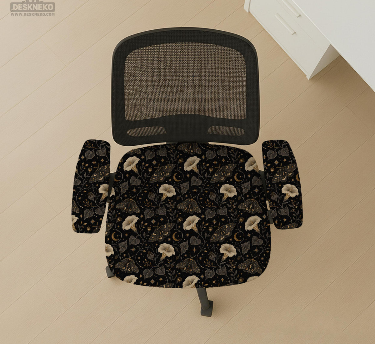 Black chair cover with a moth, moon, and flower pattern in gold, ivory, and dark botanical tones.