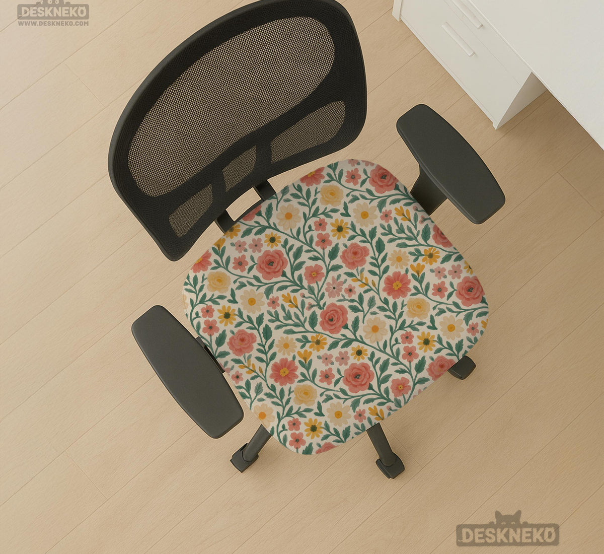Cream desk chair cover with a vintage floral print featuring coral roses, mustard daisies, and green vines on a chair.