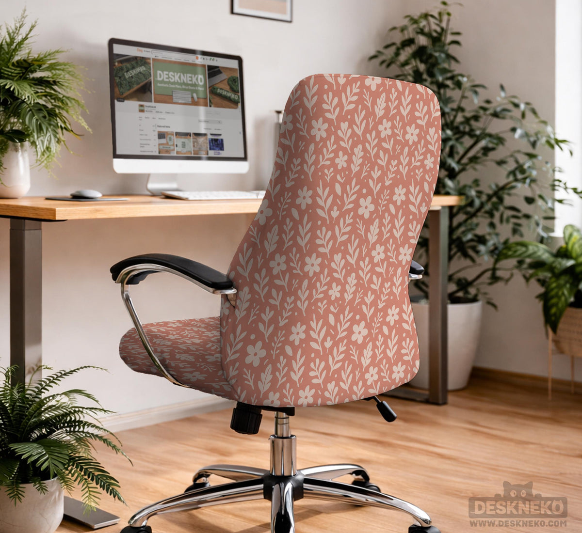 Pink chair cover with a botanical floral print shown on an office chair, with matching armrest covers and multiple cover style options.