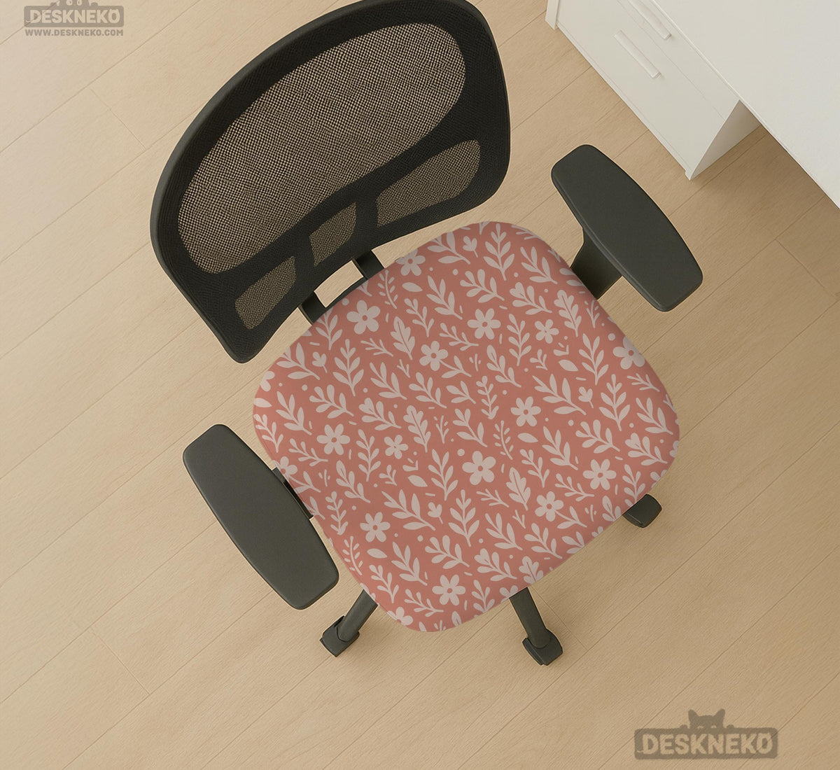 Pink chair cover with a botanical floral print shown on an office chair, with matching armrest covers and multiple cover style options.