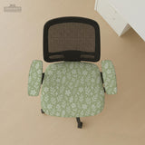 Sage green desk chair cover with a small floral and leaf print shown on an office chair.