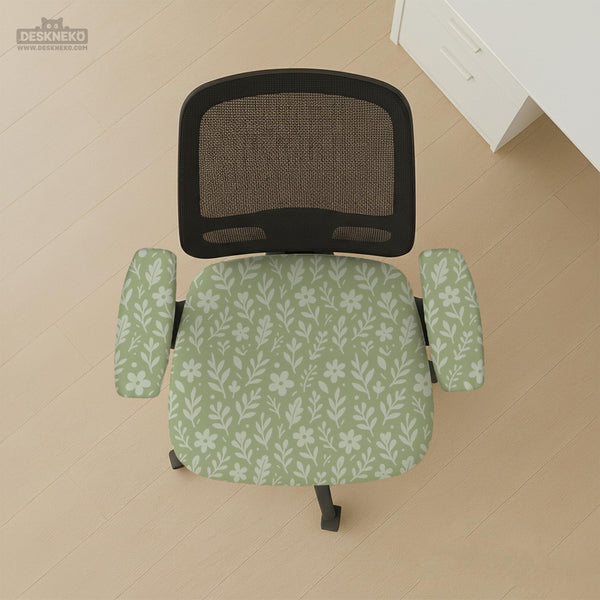 Green chair cover with a small botanical floral print in sage and cream.