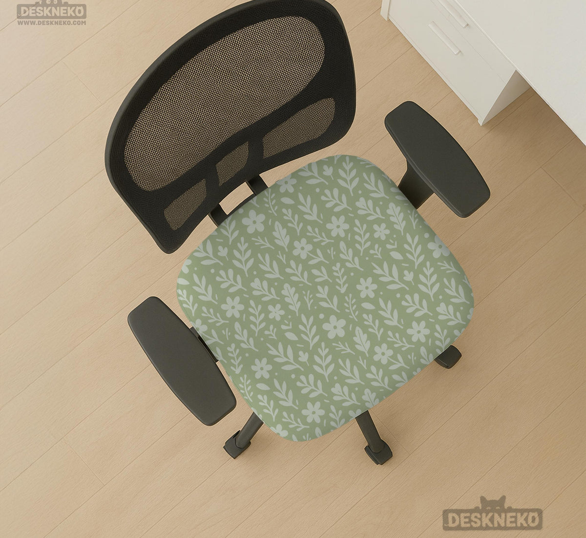 Sage green desk chair cover with a small floral and leaf print shown on an office chair.