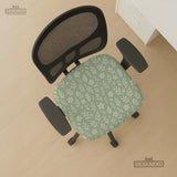 Green chair cover with a small botanical floral print in sage and cream.