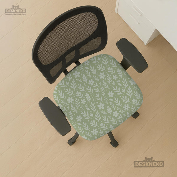 Green chair cover with a small botanical floral print in sage and cream.