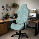 Sage and aqua green floral chair cover shown on a gaming chair with matching armrest covers.