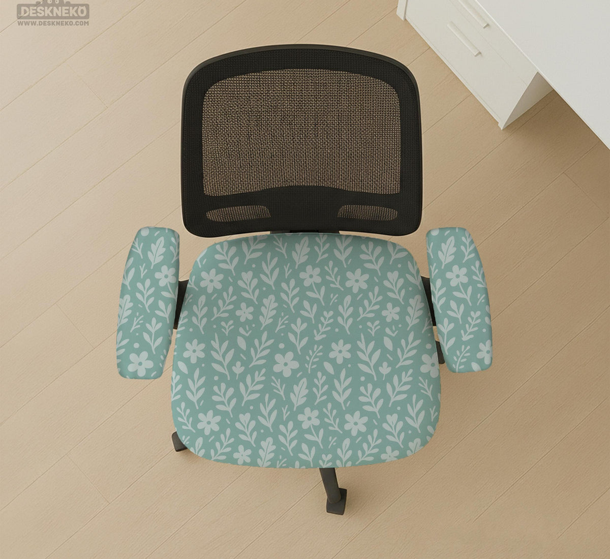Sage and aqua green floral chair cover shown on a gaming chair with matching armrest covers.