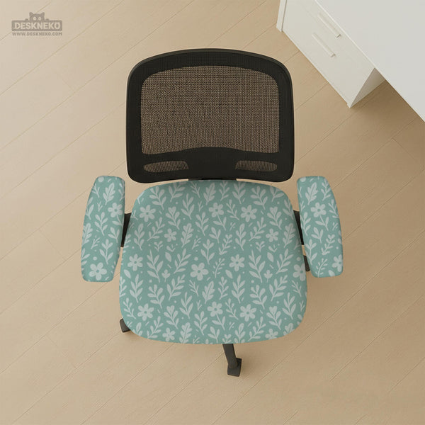Sage and aqua green floral chair cover shown on a gaming chair with matching armrest covers.