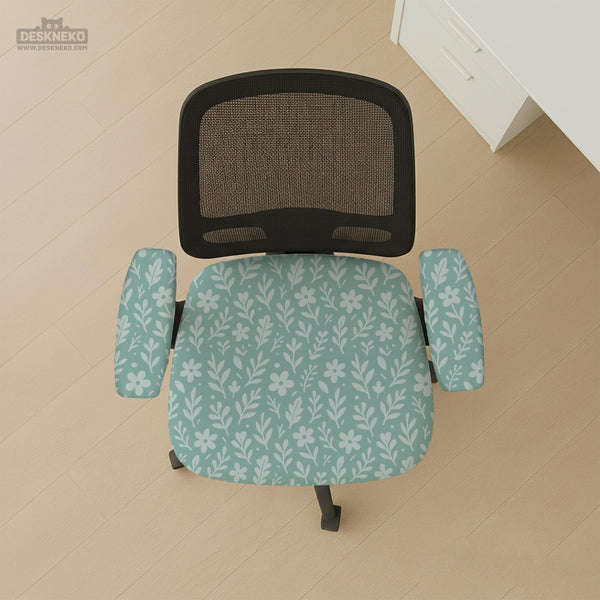 Mint and white botanical desk chair cover with a floral leaf pattern shown on an office chair.