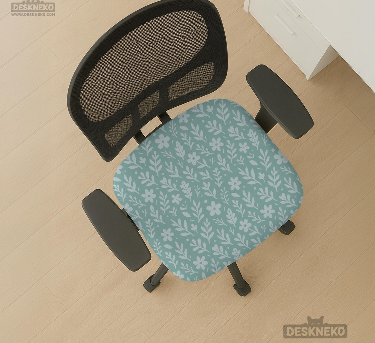 Sage and aqua green floral chair cover shown on a gaming chair with matching armrest covers.