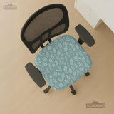 Sage and aqua green floral chair cover shown on a gaming chair with matching armrest covers.