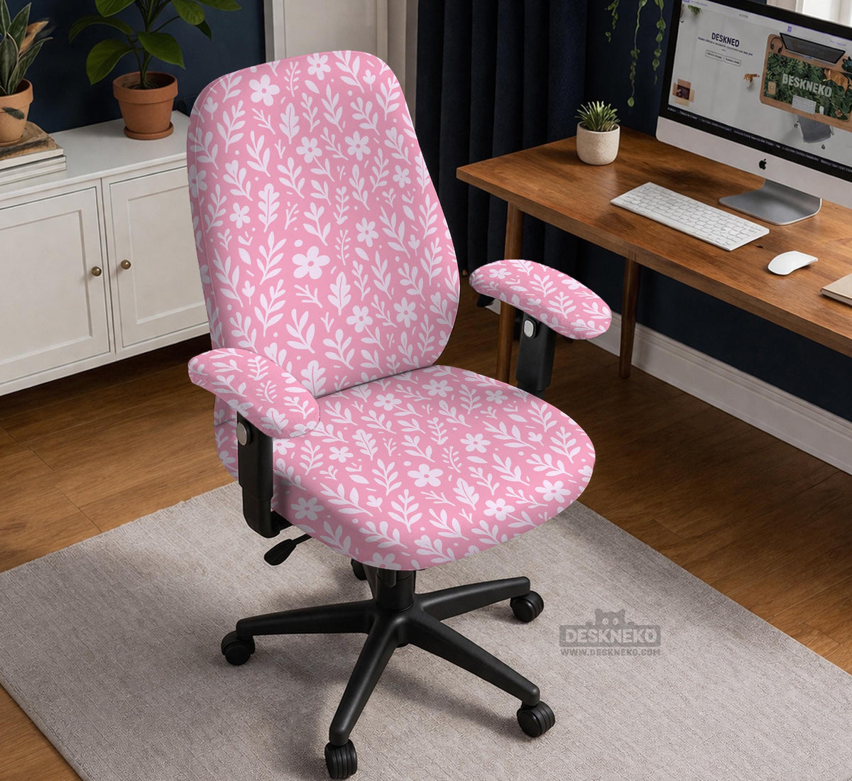 Blush pink chair cover with a small botanical floral pattern shown on an office chair.