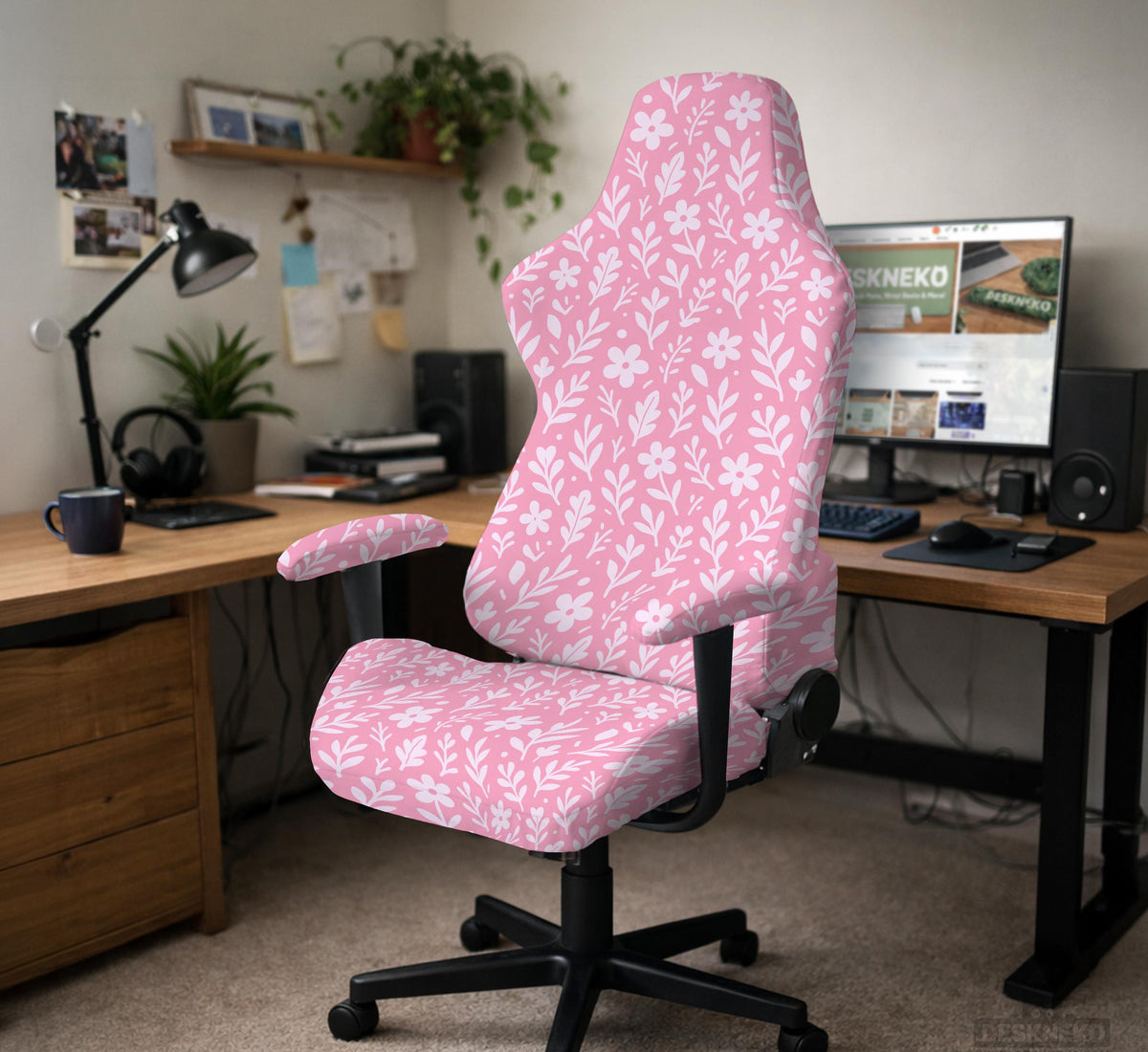Soft pink floral chair cover shown on a gaming chair with a high back and armrests.